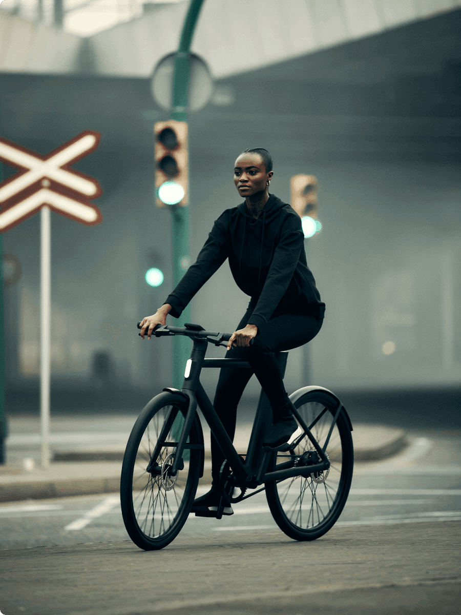 A rider on an e-bike at a city crossing.
