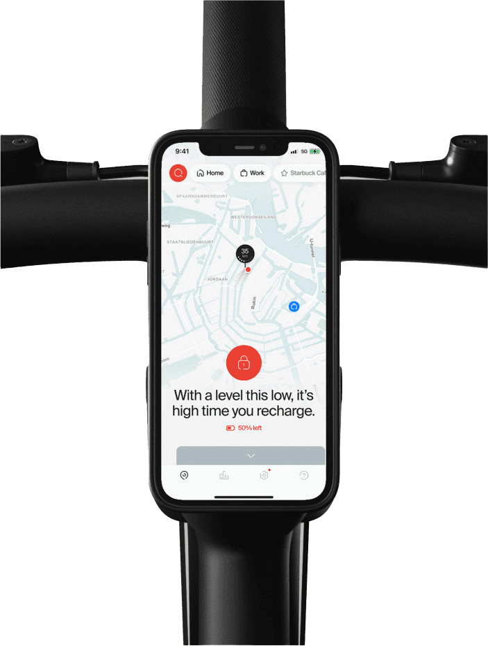 A phone on the handlebar showing a map and a low battery warning.